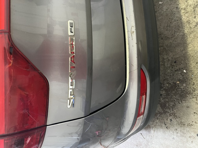 Gray rear hatch after repair around the badge