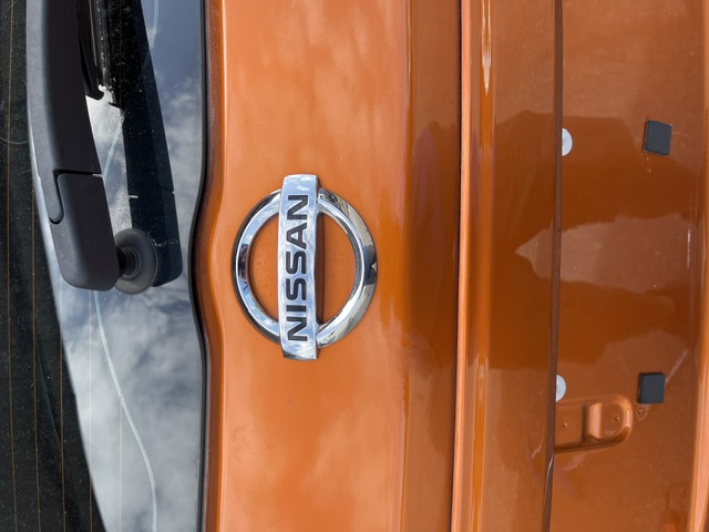 Orange rear hatch after repair, showing the reshaped body line