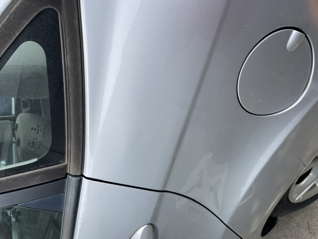 Silver rear quarter panel after repair above the fuel door